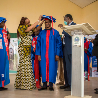 A group on stage in ceremonial robes