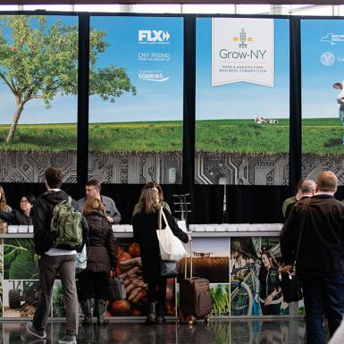 People standing in an event lobby checking in at a desk