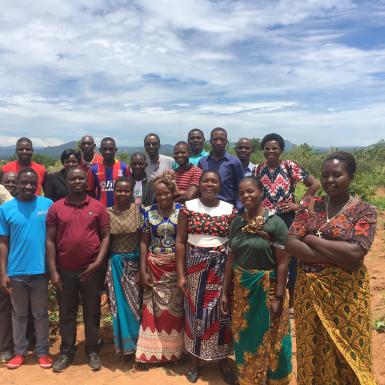 Group of Malawian farmers pose for picture in a field