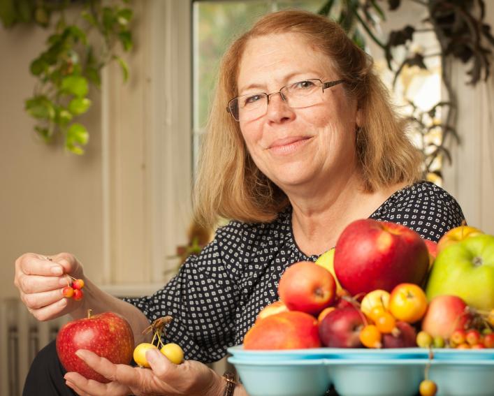 woman displaying apple varieties