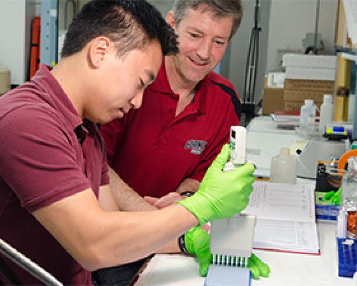 two men working together at a lab bench